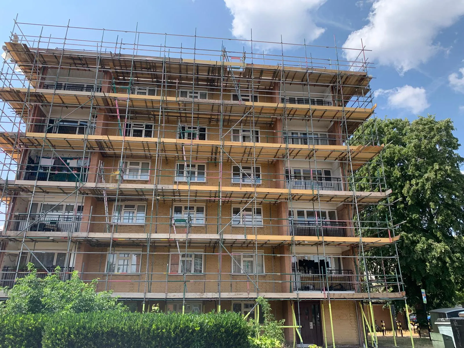 Commercial scaffolding installed across a multi-storey residential building