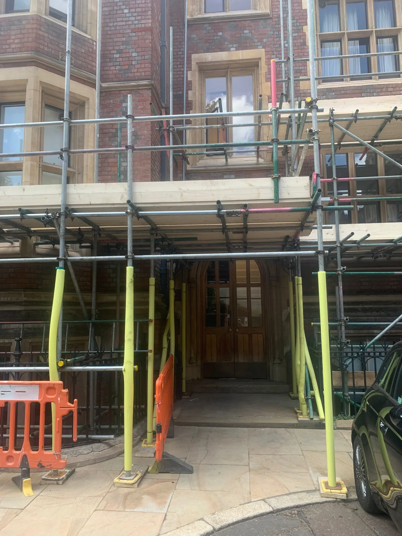 Residential scaffolding installed around a brick property