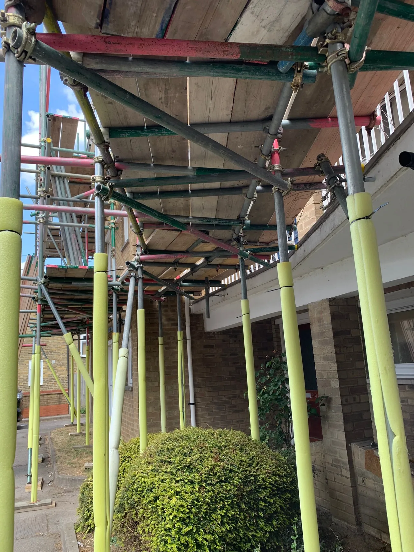 Residential scaffolding with protected access around a property entrance